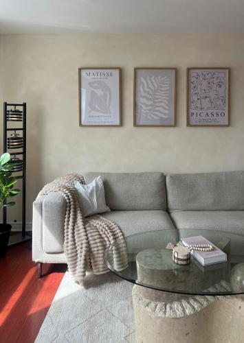 a living room with a couch and a coffee table at Cozy Bohemian Apartment in Toronto