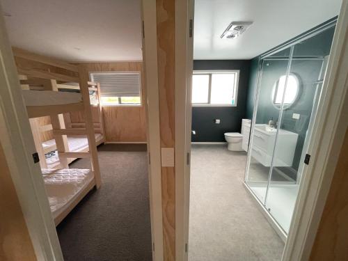 Zimmer mit Etagenbetten und einem Bad mit WC. in der Unterkunft Manawa - Ohakune Holiday Home in Ohakune