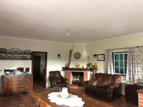 a living room with a couch and a fireplace at Casa de campo em Riachos in Riachos