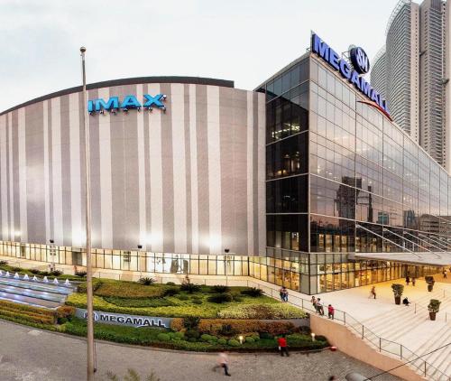 a large building with a sign on top of it at Ortigas Business District Residences in Manila
