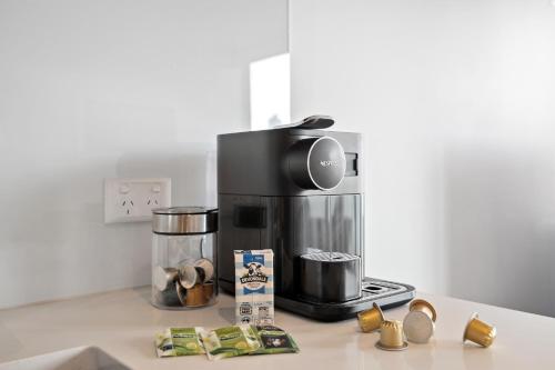 a coffee maker sitting on top of a kitchen counter at Sleek City Flat, 5-Star Location with Free Parking in Melbourne