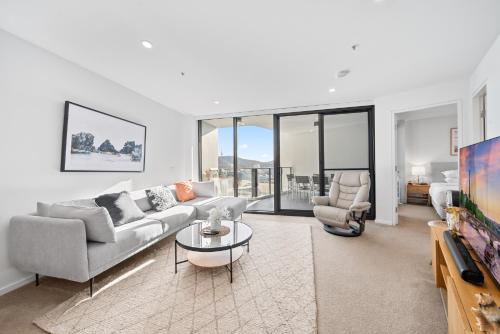 a living room with a couch and a table at Stylish 2-Bed Apartment in Canberra CBD in Canberra