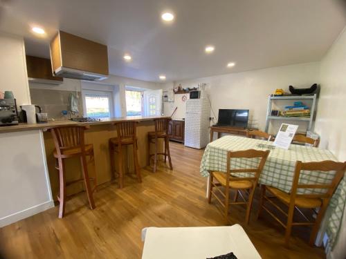 a kitchen and dining room with a table and chairs at Gîte du cerisier in Raddon-et-Chapendu