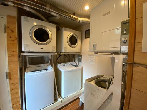 a small kitchen with a washer and dryer at ビジネスイン拝島 in Akishima
