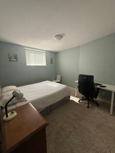 a bedroom with a bed and a desk and a chair at 2 bedroom Suite with private entrance in Langley