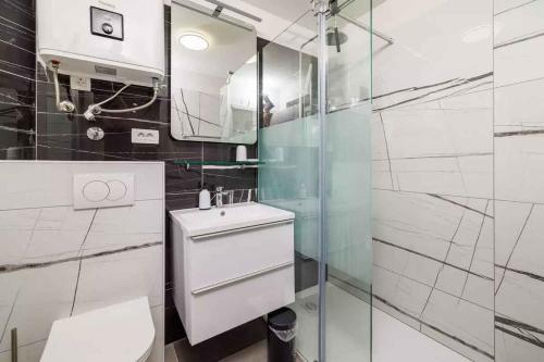 a bathroom with a toilet and a glass shower at Apartment in Bribir 50595 in Bribir