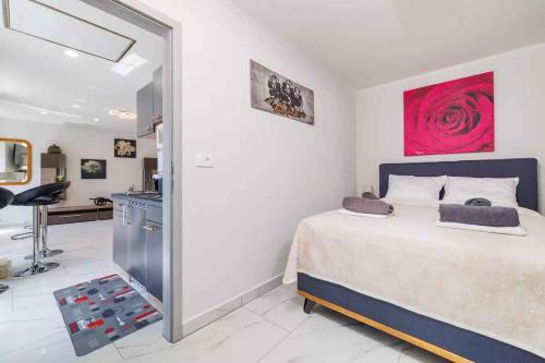 a bedroom with a large bed and a kitchen at Apartment in Bribir 50595 in Bribir