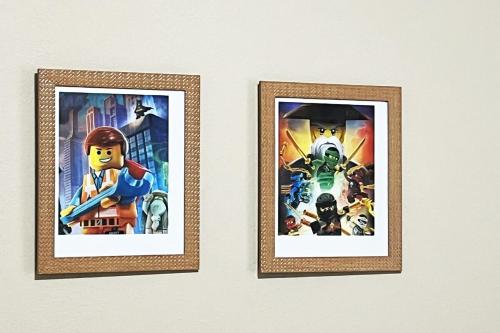 three framed pictures of the lego movie on a wall at BlockHaven near Legoland, Disney in Winter Haven