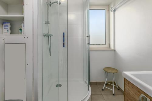 a bathroom with a shower and a toilet and a sink at Rietpanne 0106 in Koksijde