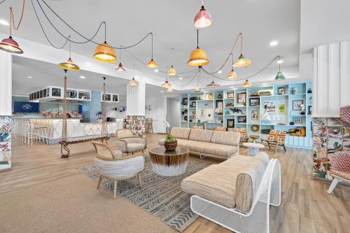 a large living room with couches and chairs at Blue Flamingo Resort Key West in Key West
