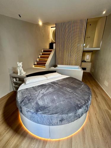 a large bed in a room with a staircase at Renard Suite in Cefalù
