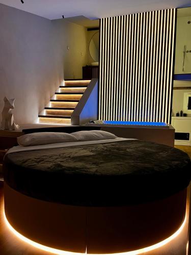 a bedroom with a large bed with lights on it at Renard Suite in Cefalù