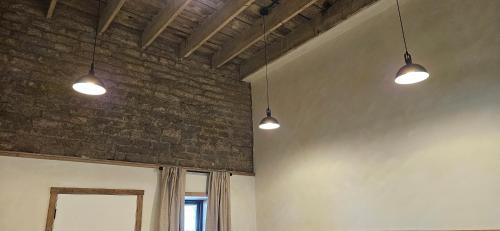 two lights are hanging from a brick wall at Inn History Tombstone in Tombstone