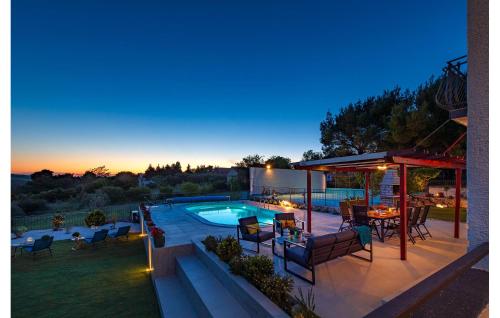 a backyard with a pool and a table and chairs at Villa Plenca in Šibenik
