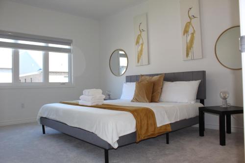 a bedroom with a large bed with a mirror at Detached New Modern House In South Barrie - Built H plus ME Technology in Barrie