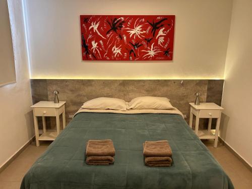 a bedroom with a large bed with two night stands at Hotel Vista Kau in Añelo