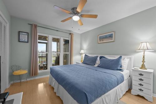 a bedroom with a bed and a ceiling fan at Sea La Vie- Oceanfront Family Retreat in North Topsail Beach