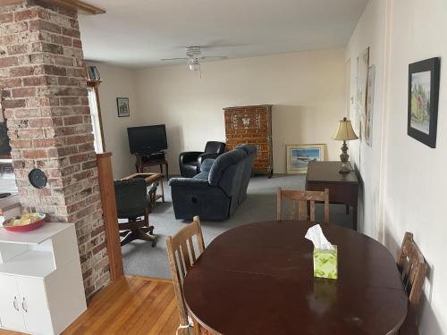 a dining room and living room with a table and chairs at Seine Boat Inn in Alert Bay