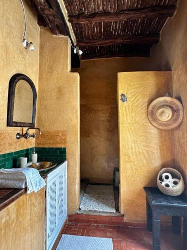 a bathroom with a sink and a counter with a mirror at Behind js in Essaouira