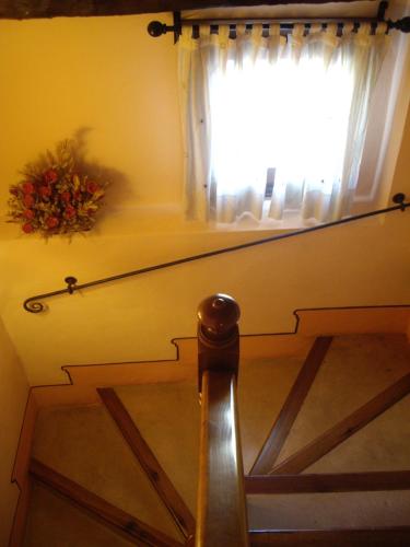 a stairway with a window and a stair case with a stair at Hotel la Casa del Abuelo in Albarracín