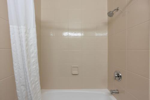a bathroom with a shower with a white shower curtain at Quality Inn in Havre