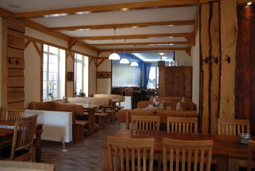 a dining room with wooden tables and chairs at Hotel Stangl in Hamm