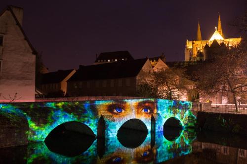 a bridge with an eye painted on it at night at Hotel & Spa Le Grand Monarque, BW Premier Collection in Chartres