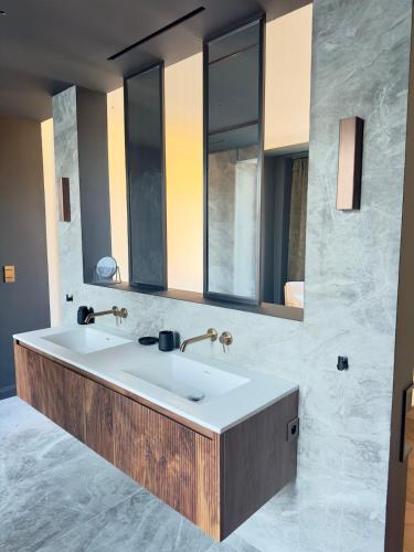 a bathroom with a large sink and a mirror at Otentik Noblesse Royal View in Metz