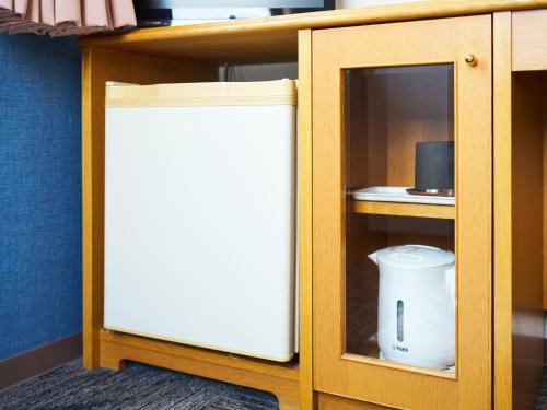 a cabinet with a white refrigerator in a room at Hotel Fukui Castle - Vacation STAY 58692v in Fukui