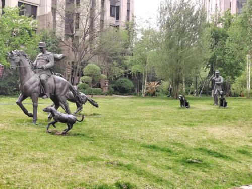 a statue of a man riding a horse and a dog at Central Street Apartment 1 in Harbin