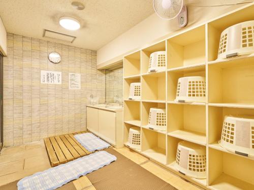 a bathroom with white shelves and a shower at Hotel Fukui Castle - Vacation STAY 58692v in Fukui