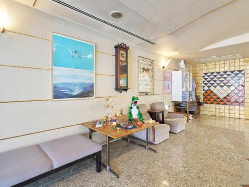 a living room with a table and a couch at Hotel Fukui Castle - Vacation STAY 58692v in Fukui
