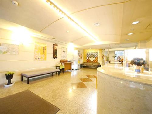 a large lobby with a couch and a waiting room at Hotel Fukui Castle - Vacation STAY 58692v in Fukui