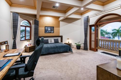 a bedroom with a bed and a desk and a table at Bellagio Gold Coast in Gold Coast