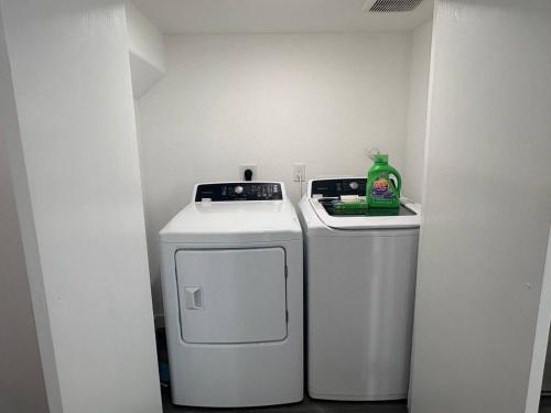 a small bathroom with a washer and dryer in a room at The Divine 3 - Townhome with AC, WiFi in Beautiful Houston in Houston