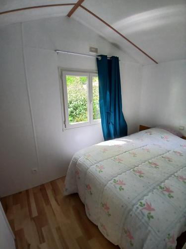 une chambre avec un lit et une fenêtre dans l'établissement Mobil-home confort 2 chambres à La Baule, à La Baule