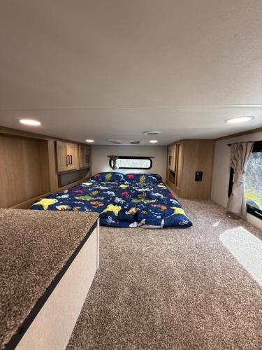 a large bed in the middle of a room at Stylish RV with 2 Bedrooms, 2 Lofts and 2 Bathrooms in Key Largo