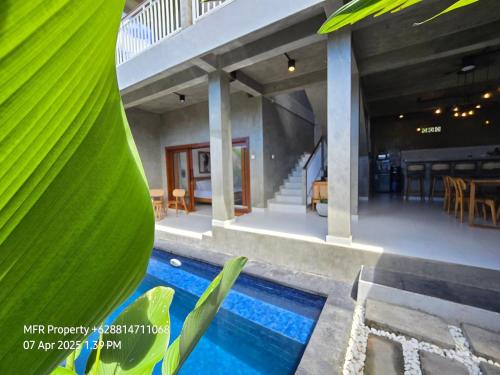 a villa with a swimming pool and a house at Prime Location Villa Berawa Canggu 3bed in Canggu
