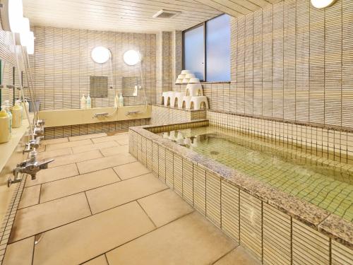 a large bathroom with a large pool of water at Hotel Fukui Castle - Vacation STAY 58712v in Fukui