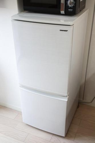 a white refrigerator with a microwave on top of it at Isole le Olena 201 in Naha