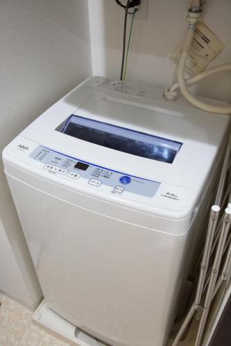 a washing machine with a window on top of it at Isole le Olena 201 in Naha