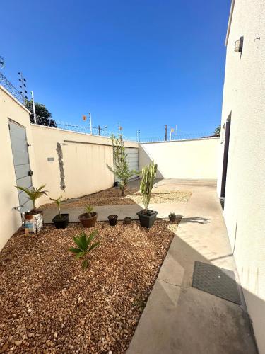 a sidewalk next to a building with plants at Casa Davisis 2 - Parada Jalapão, Prox Rodoviária, Aeroporto e Faculdades in Palmas