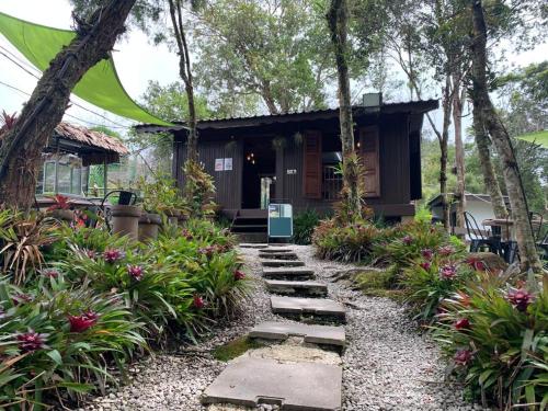 a garden path leading to a house at The Jerai Hill Resort in Yan