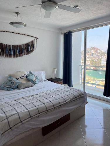 a bedroom with a bed with a view of the ocean at apartment with sea and Island views in Acapulco