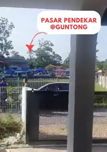 a car parked in front of a parking lot at Homestay Pendekar Guntong in Kampong Jereneh