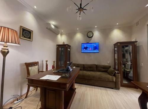 a living room with a desk and a couch at Museum Boutique Luxury GH in Sheki
