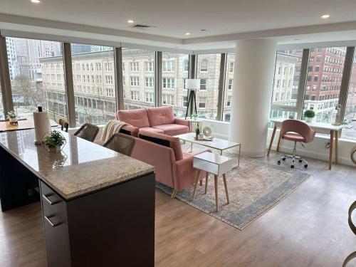 a living room with a couch and a table at Upscale 2BR Condo with Gym & Parking near MGH & TUFTS in Boston