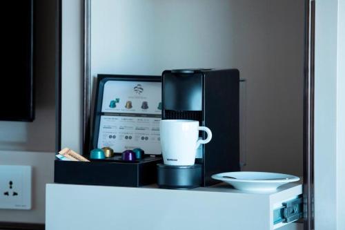 a coffee maker and a cup on top of a counter at Yokohama Royal Park Hotel in Yokohama