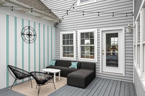 a patio with a couch and a table and chairs at Harkers Haven home in Harkers Island