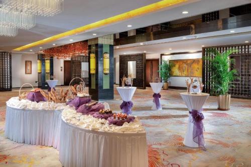 a lobby with three tables with food on them at Radegast Hotel CBD in Beijing